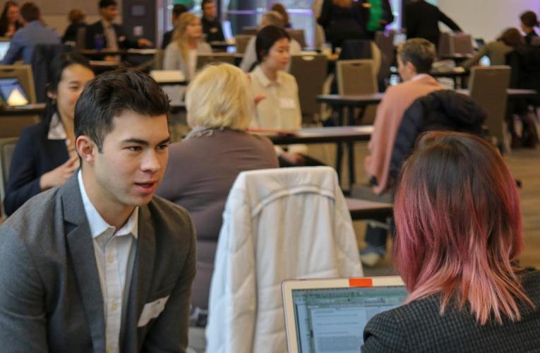 Student interviewing at an event