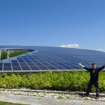 Student in front of a solar panel