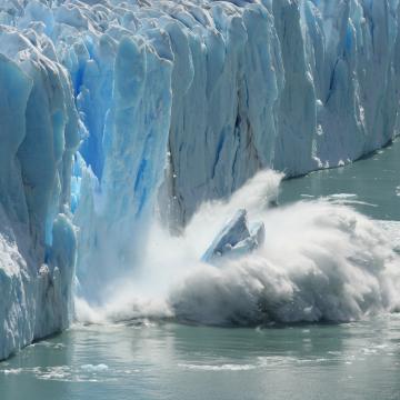 An iceberg breaking off a glacier